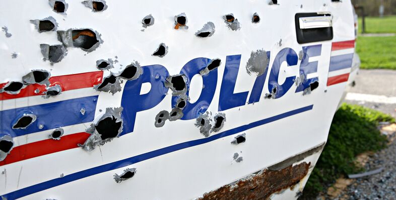 A police car with bullet holes