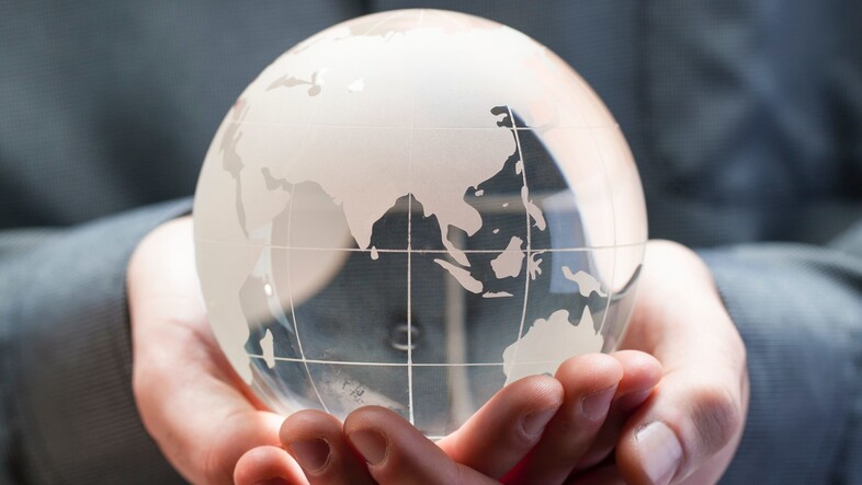 Hands holding globe