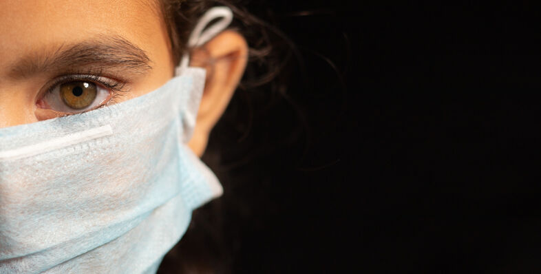 A photo of a girl wearing a surgical mask