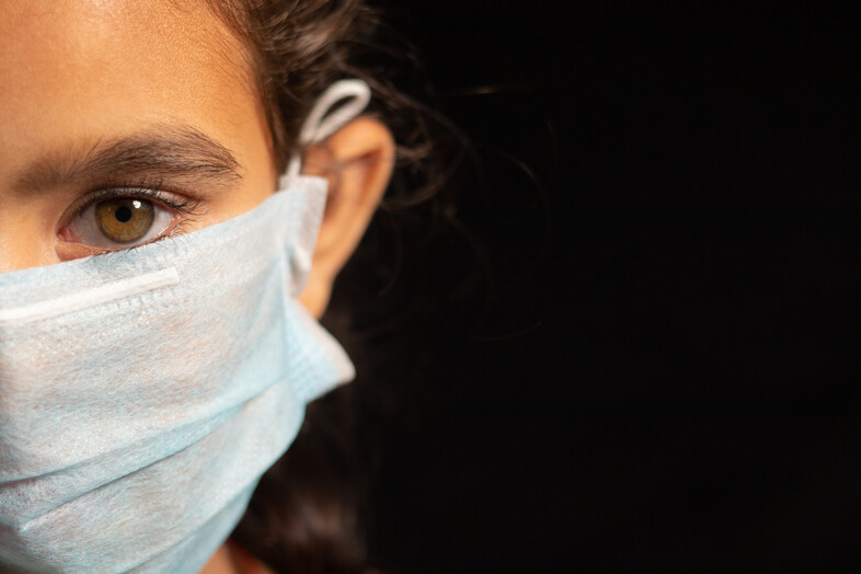 A photo of a girl wearing a surgical mask