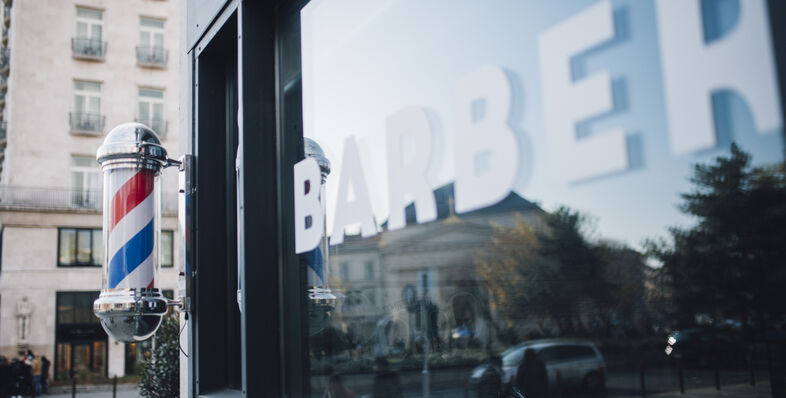 A photo of a barbershop window