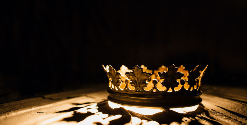 A crown with light shining through it