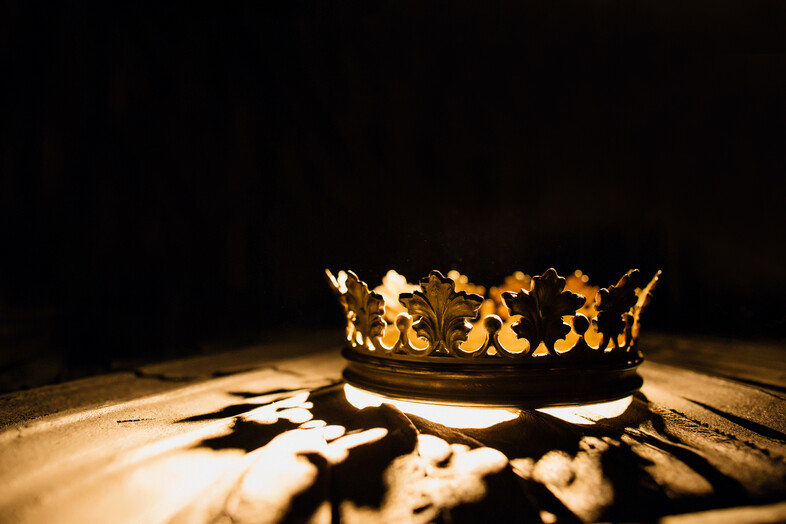 A crown with light shining through it