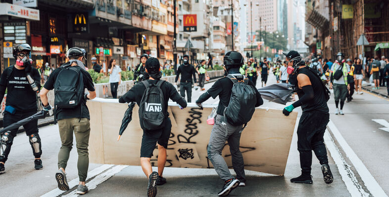 A group of men carrying a board