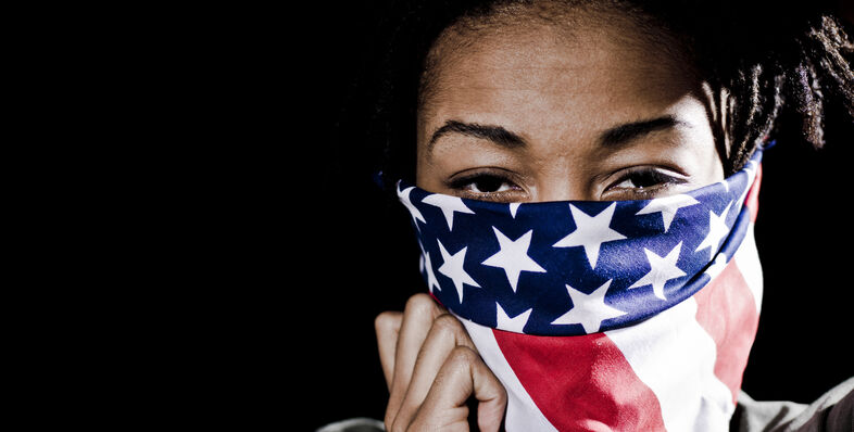 A woman wearing an American flag mask