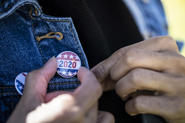 An image of a woman wearing a denim jacket with a 2020 election button