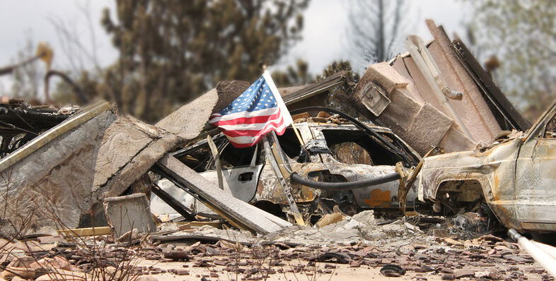 An American flag sitting on top of rubble