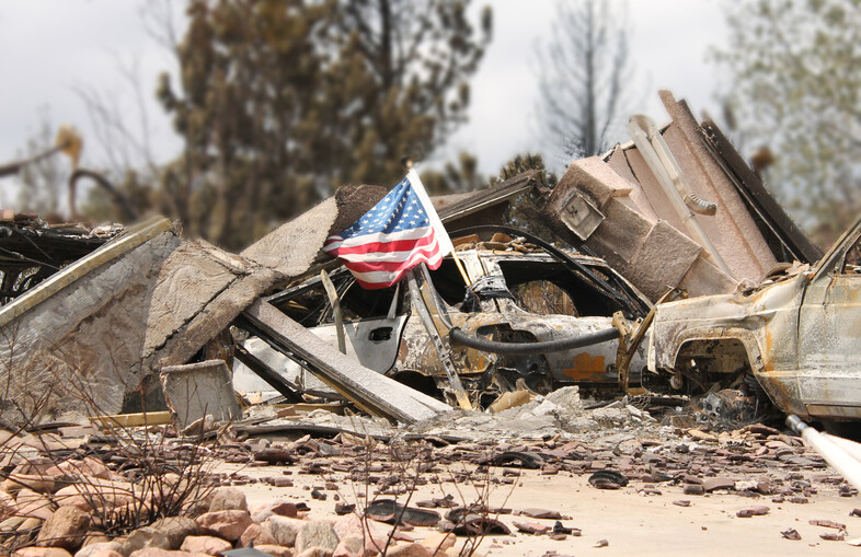 An American flag sitting on top of rubble