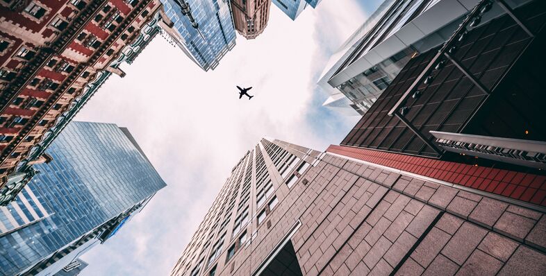 Plane flying over city