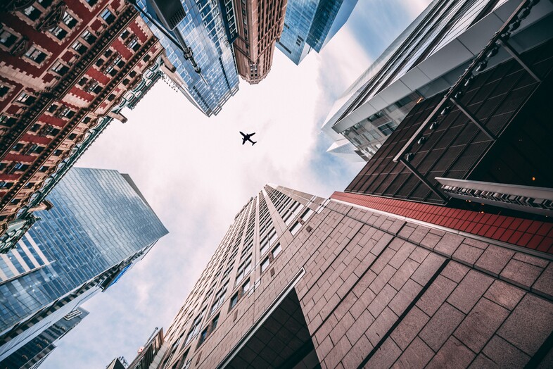 Plane flying over city