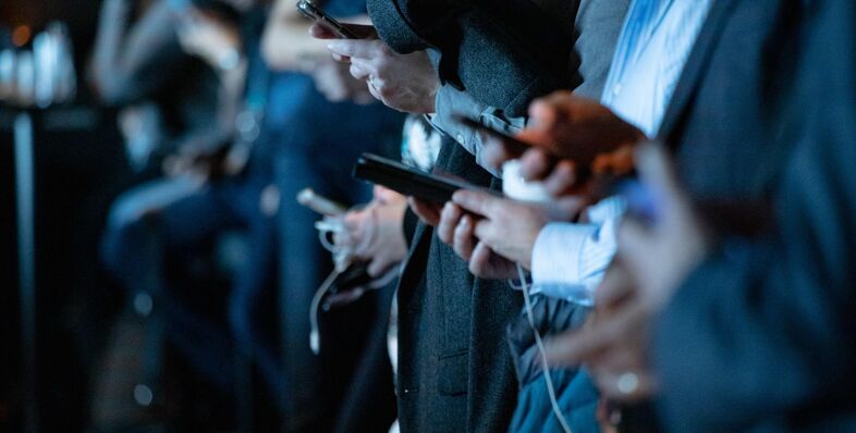 People using phone while standing